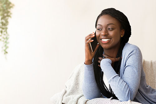 Smiling young African American woman on telehealth appointment